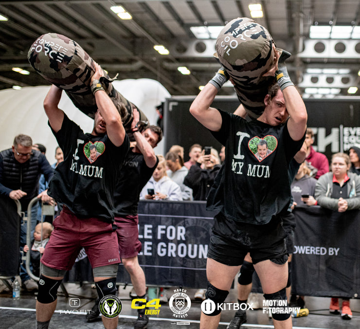 "Battle for Middle Ground athletes utilizing the durable 2-Person Worm to master lifts, carries, and team movements."